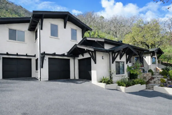 a front view of a house with a garden