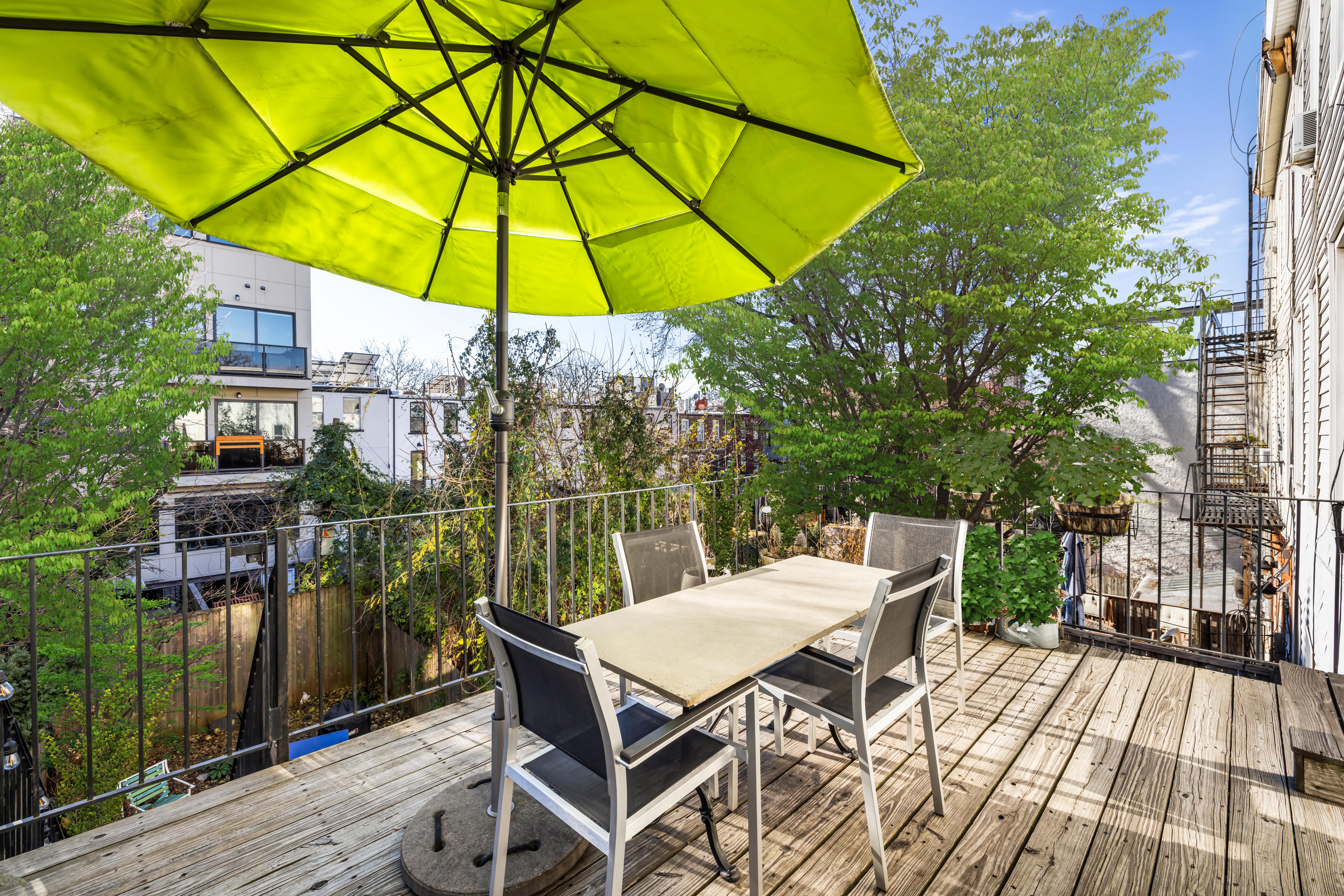 226 11th Street, Unit 2 Brooklyn, NY 11215 - Photo 15 of 19 a view of a patio with table and chairs under an umbrella