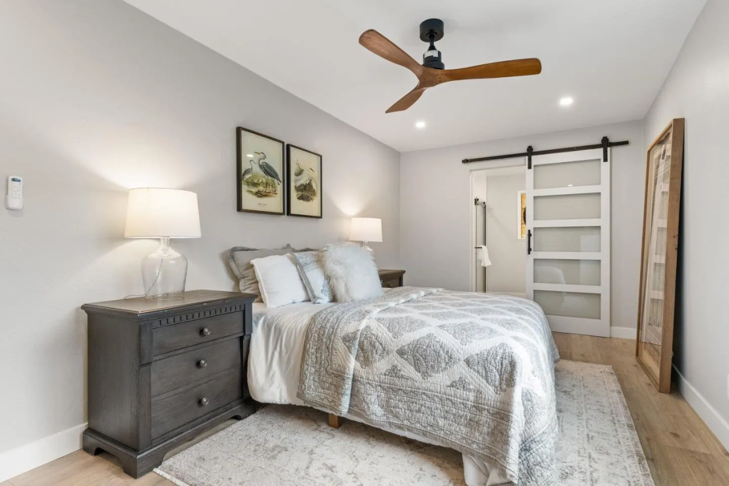 a spacious bedroom with a bed and a ceiling fan