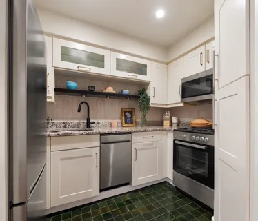 a kitchen with stainless steel appliances granite countertop a stove and a sink