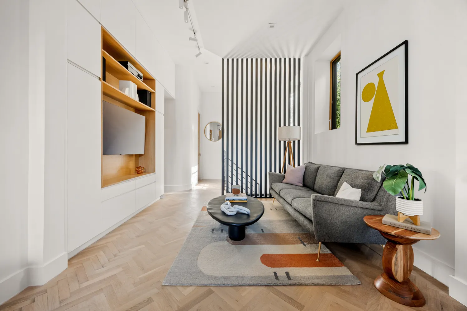 a living room with furniture and a potted plant