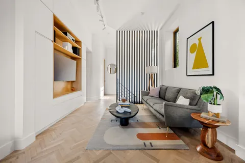 a living room with furniture and a potted plant