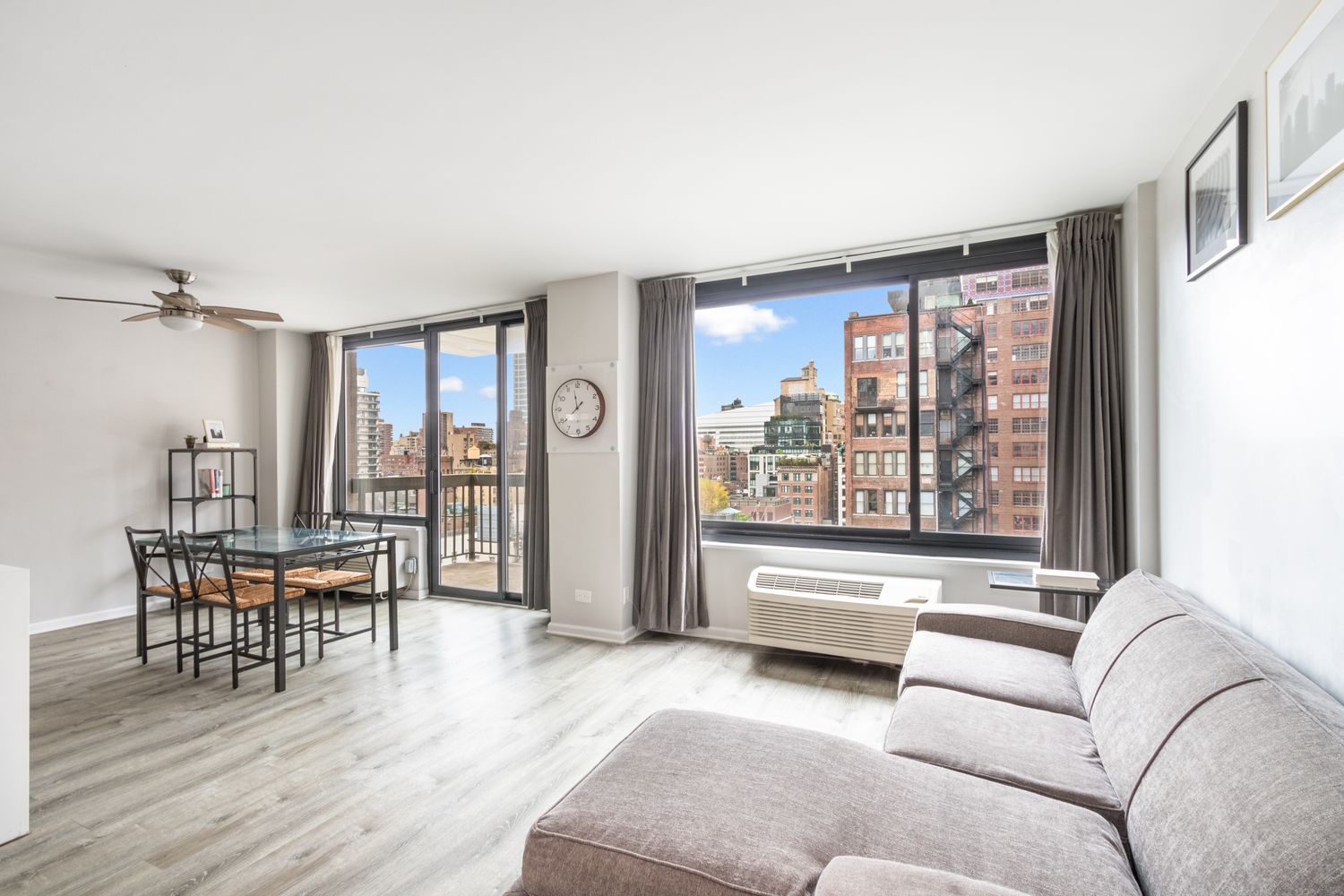 111 East 30th Street, Unit 14A Manhattan, NY 10016 - Photo 3 of 16 a living room with furniture and a large window