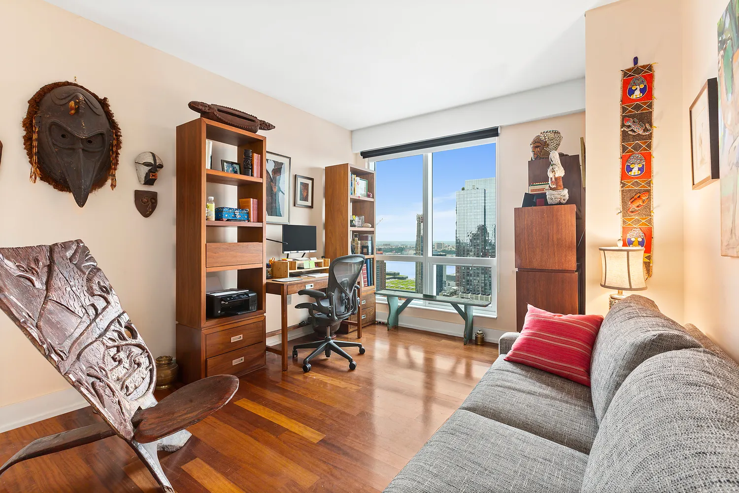 a living room with furniture and a floor to ceiling window
