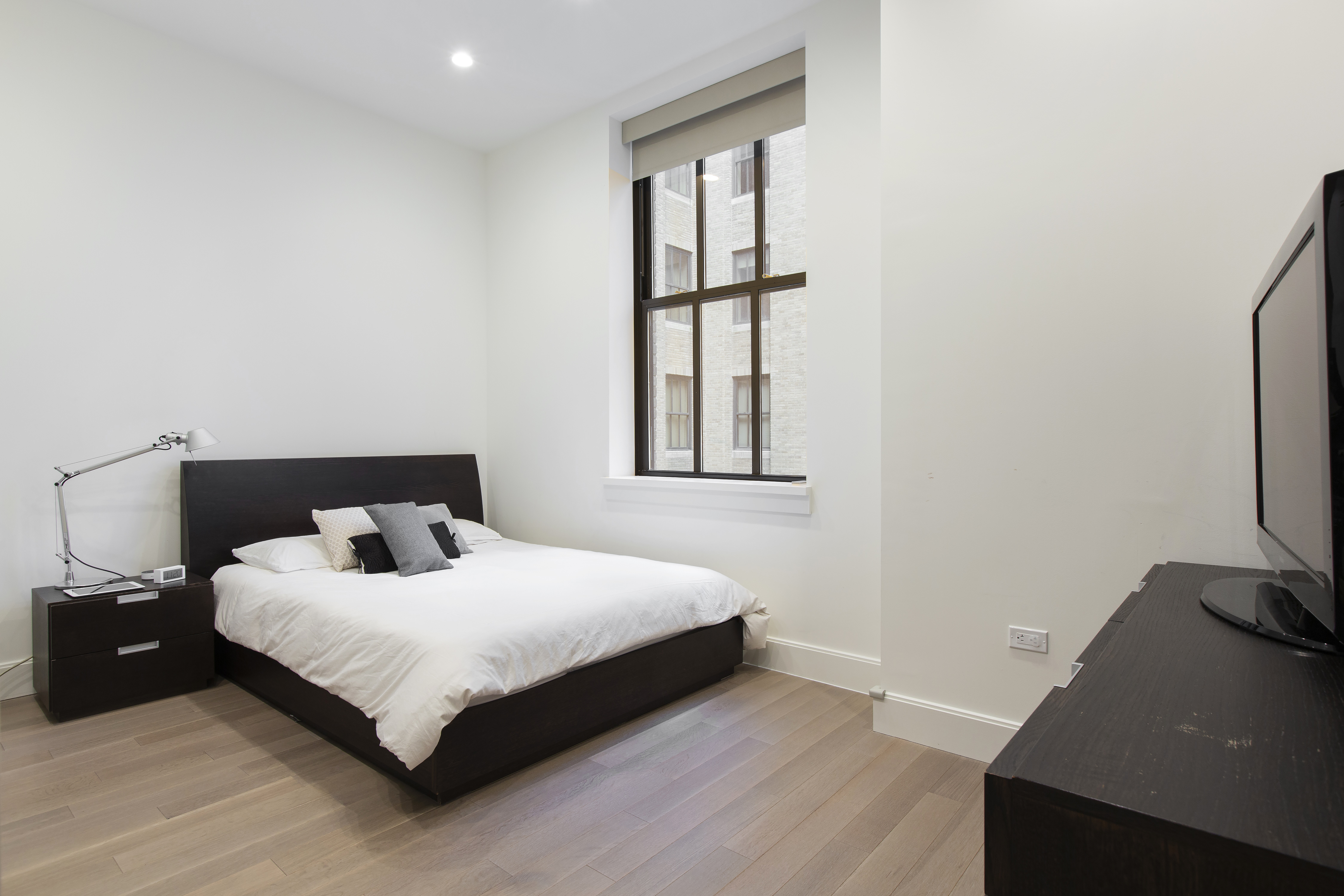 100 Barclay Street, Unit 14K Manhattan, NY 10007 - Photo 4 of 9 a bedroom with a bed and a window