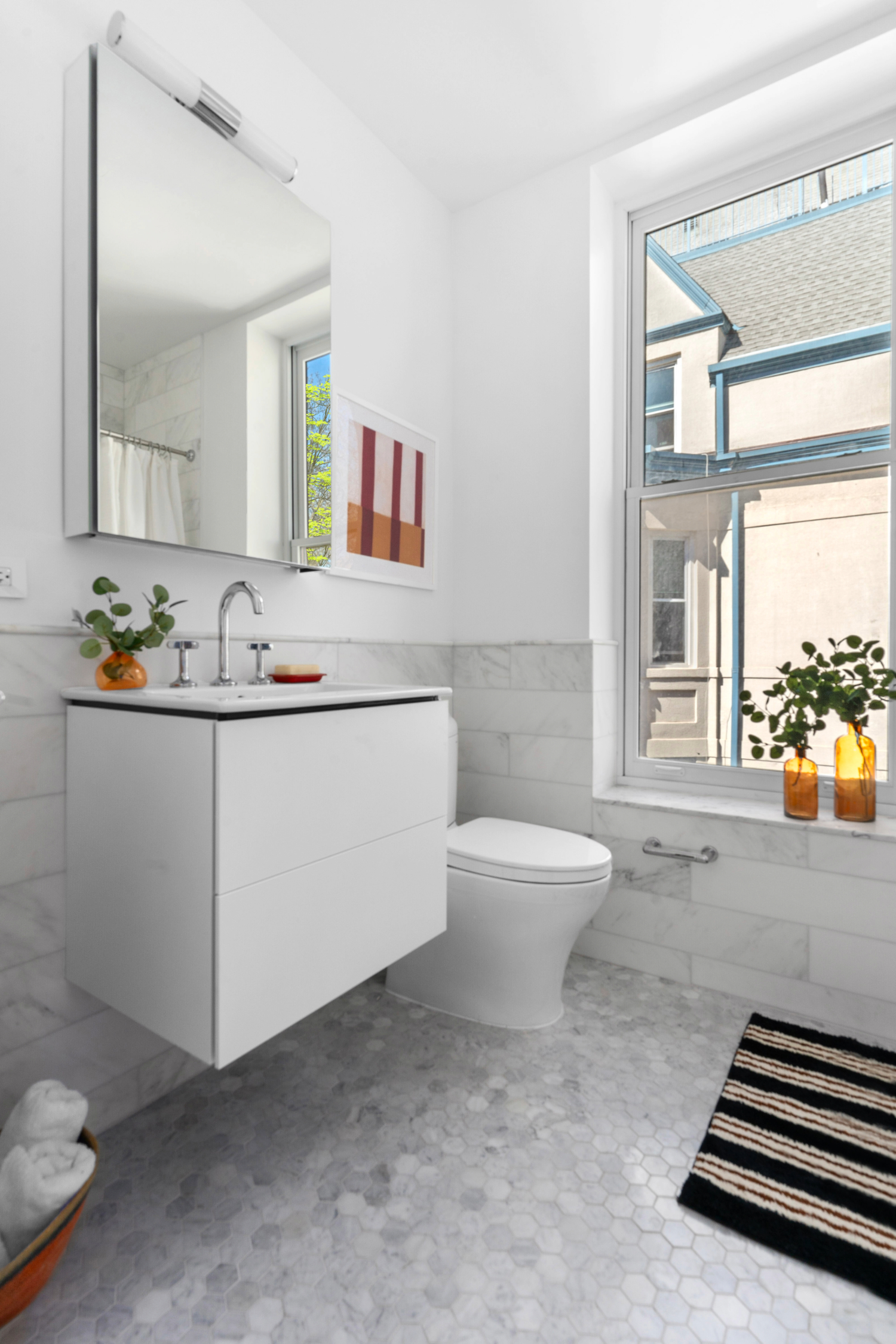 1370 Dean Street, Unit C Brooklyn, NY 11216 - Photo 4 of 7 a bathroom with a sink a toilet and mirror