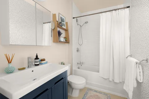 a bathroom with a sink a toilet and shower curtain