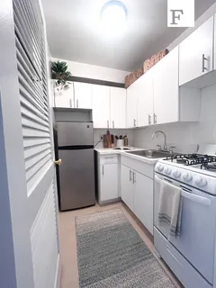 a kitchen with a white cabinets and white appliances