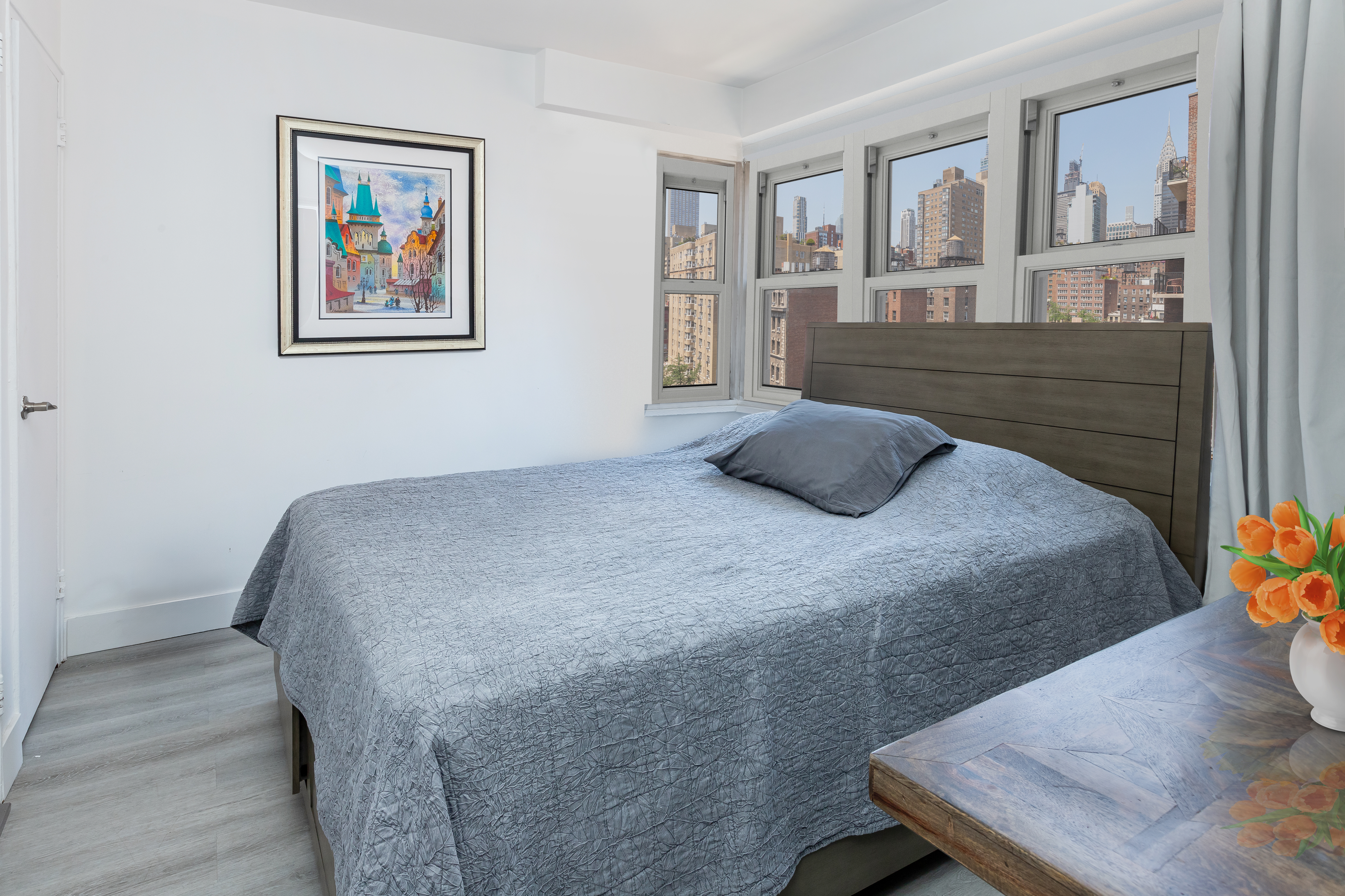 166 East 35th Street, Unit 12C Manhattan, NY 10016 - Photo 3 of 8 a bedroom with a bed and painting on the wall