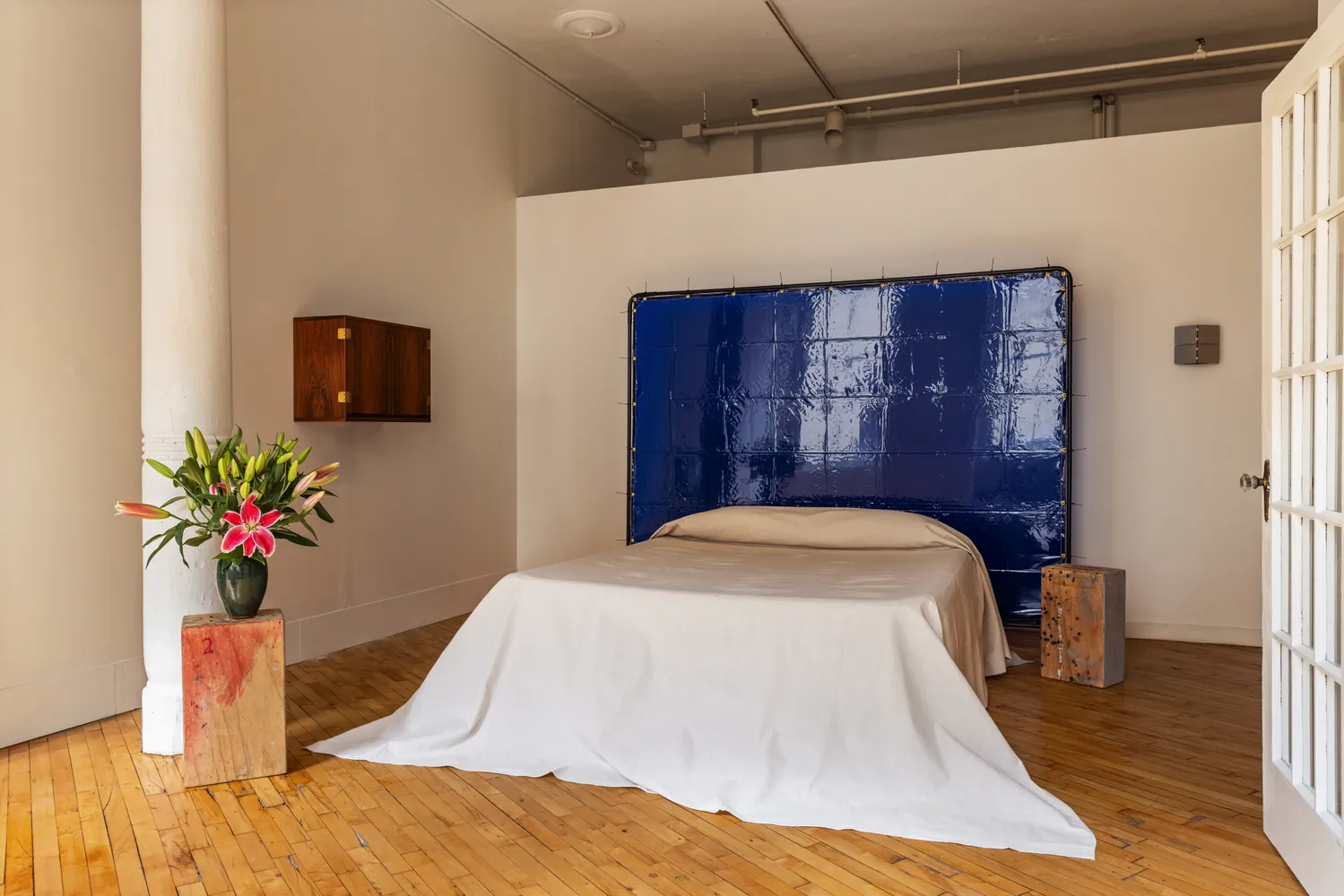 a bed in a room next to a window