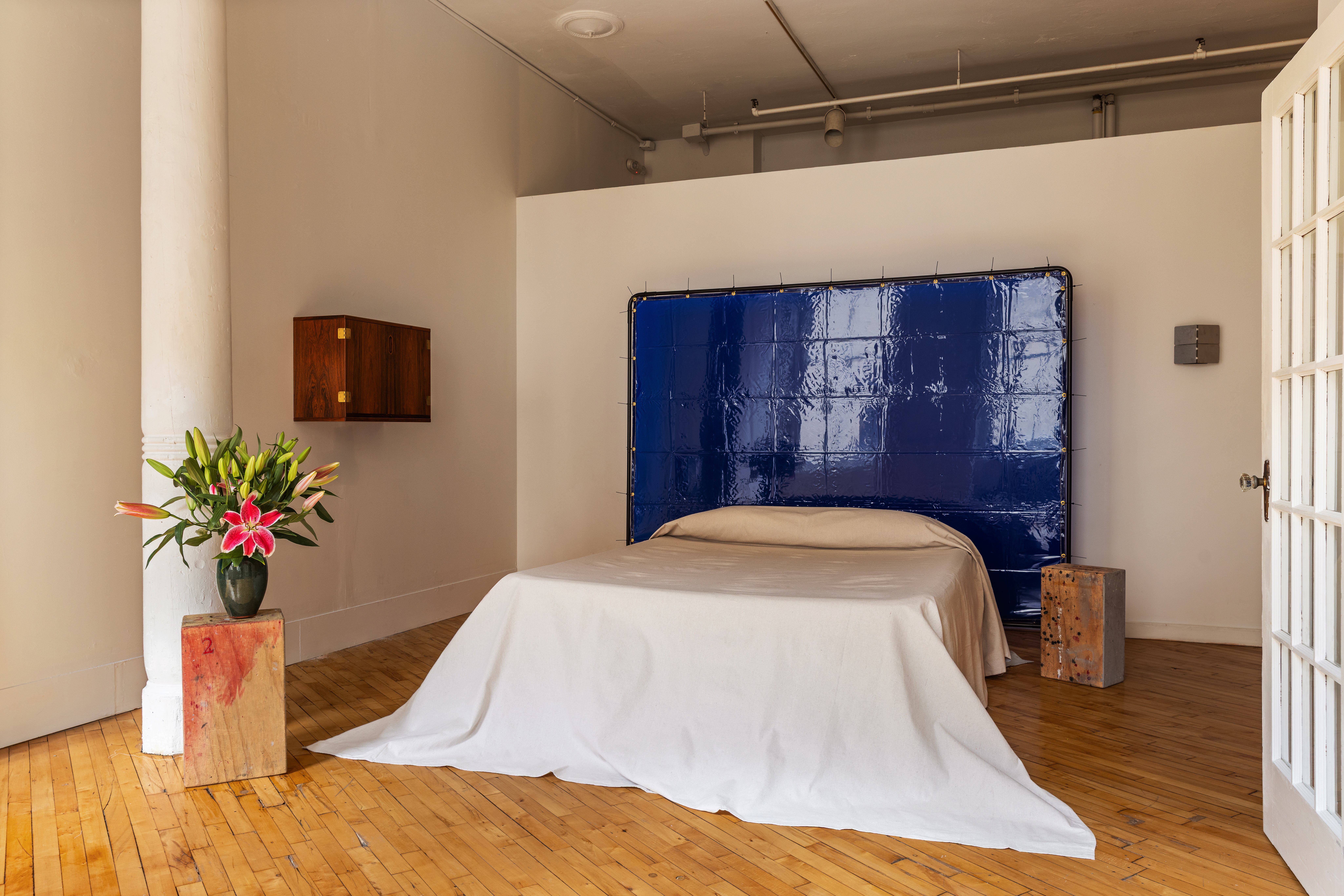 515 Broadway, Unit 4B Manhattan, NY 10012 - Photo 9 of 13 a bed in a room next to a window