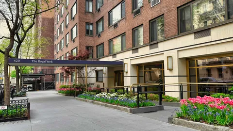 a front view of a building with a garden