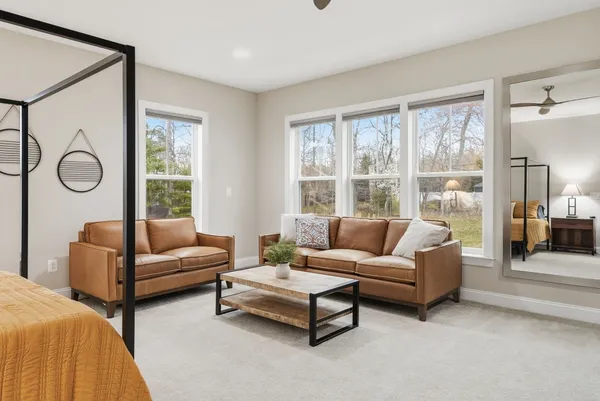 a bedroom with furniture and a flat screen tv