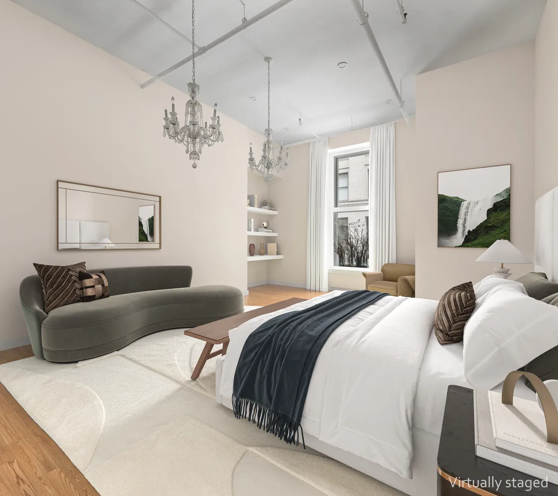 a bedroom with a large bed and a window