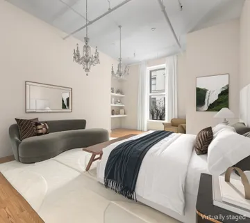 a bedroom with a large bed and a window