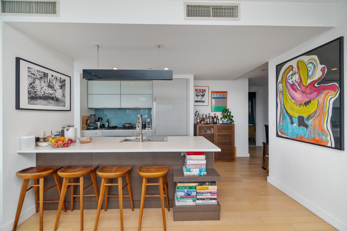 22 North 6th Street, Unit 18D Brooklyn, NY 11249 - Photo 2 of 9 a kitchen with stainless steel appliances kitchen island granite countertop a sink and cabinets