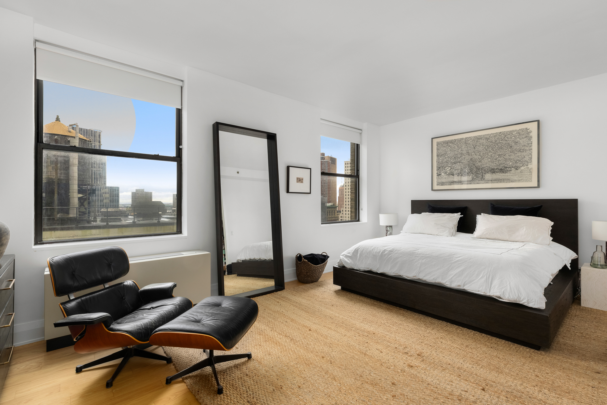 150 Nassau Street, Unit 19A Manhattan, NY 10038 - Photo 4 of 16 a bedroom with a bed and wooden floor