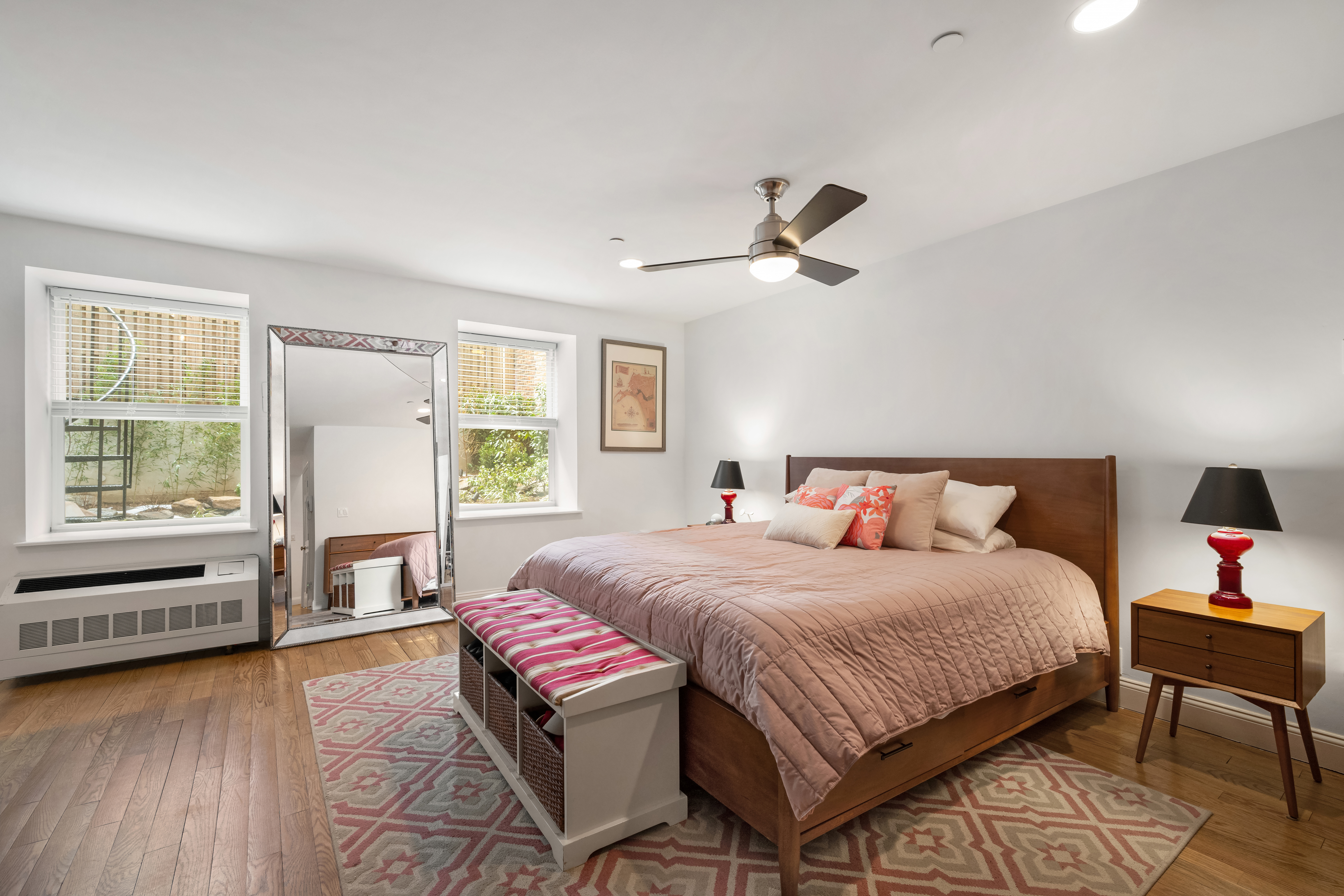 302 West 122nd Street, Unit 1 Manhattan, NY 10027 - Photo 9 of 13 a bedroom with a bed chandelier and a window