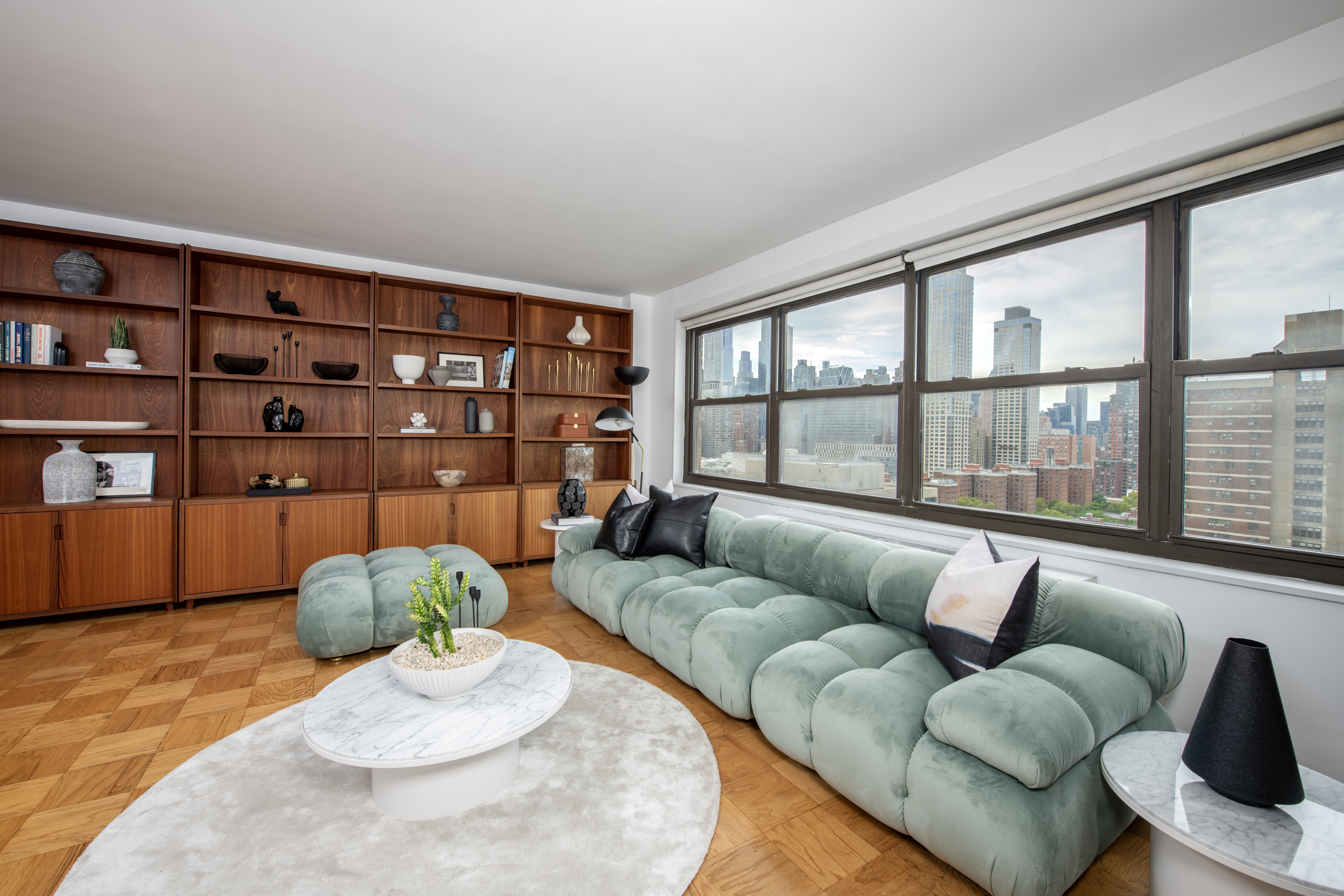 140 West End Avenue, Unit 24D Manhattan, NY 10023 - Photo 2 of 16 a living room with furniture and a wooden floor