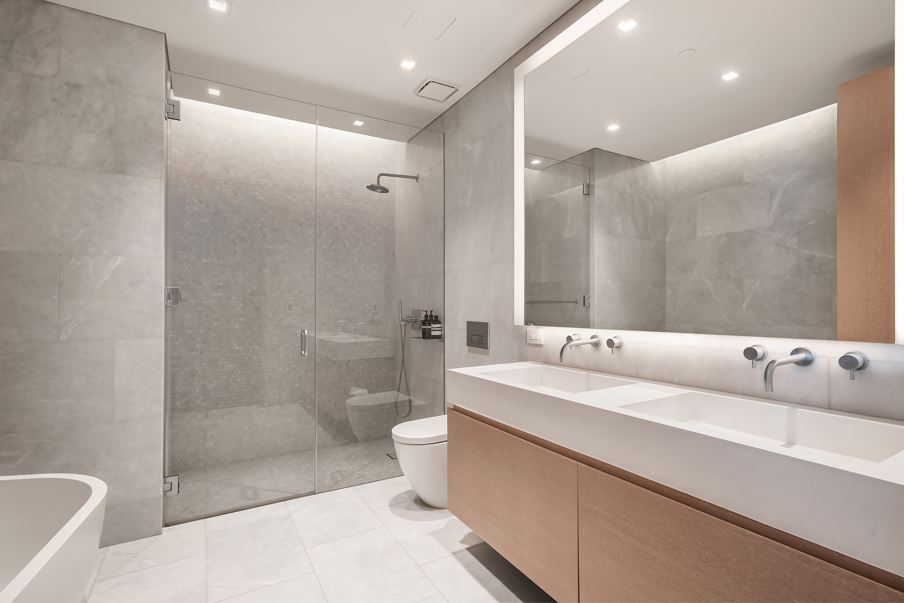 49 Chambers Street, Unit 11D Manhattan, NY 10007 - Photo 10 of 30 a bathroom with a bathtub shower sink vanity and toilet