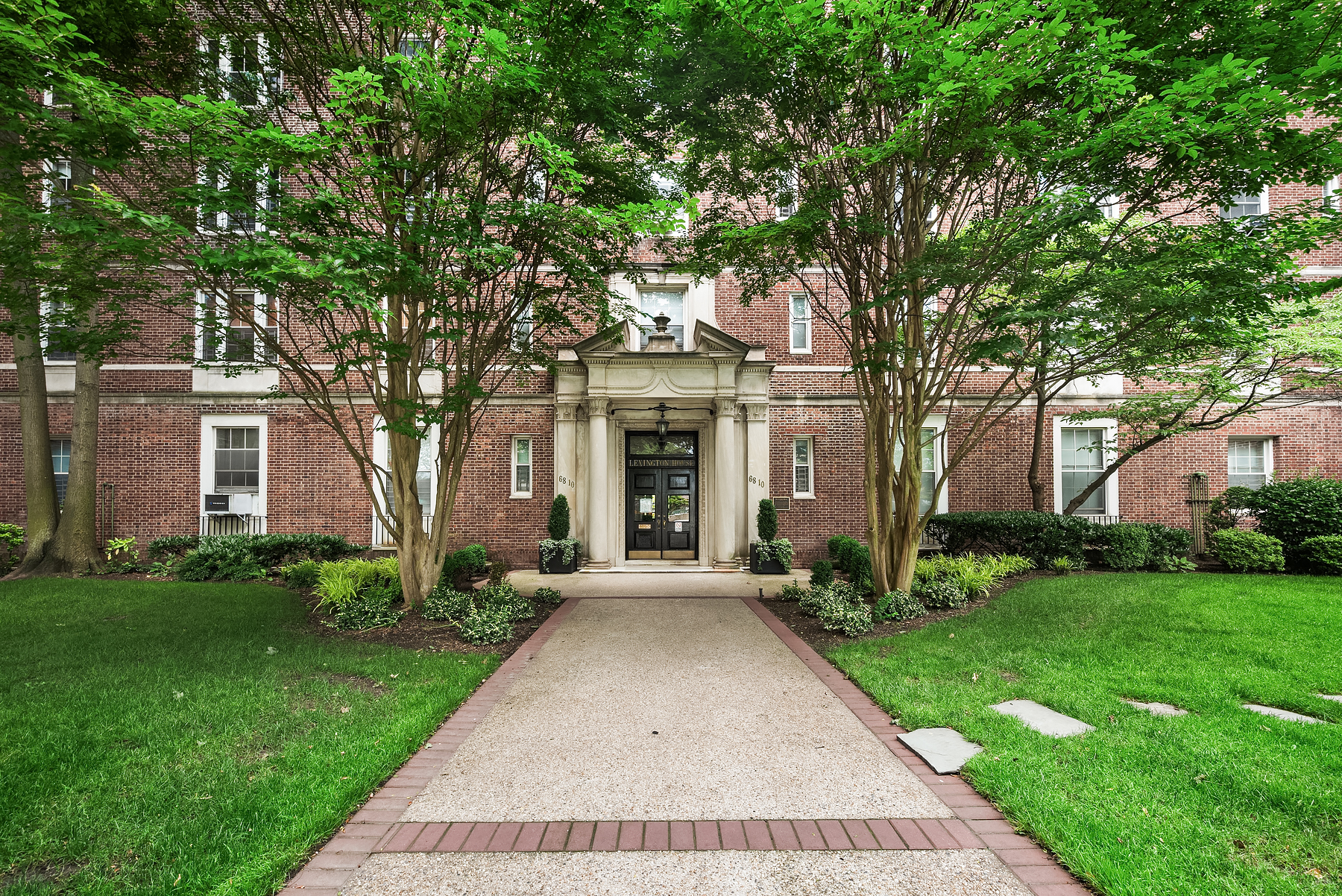 68-10 108th Street, Unit 6D Queens, NY 11375 - Photo 8 of 15 front view of a house with a yard