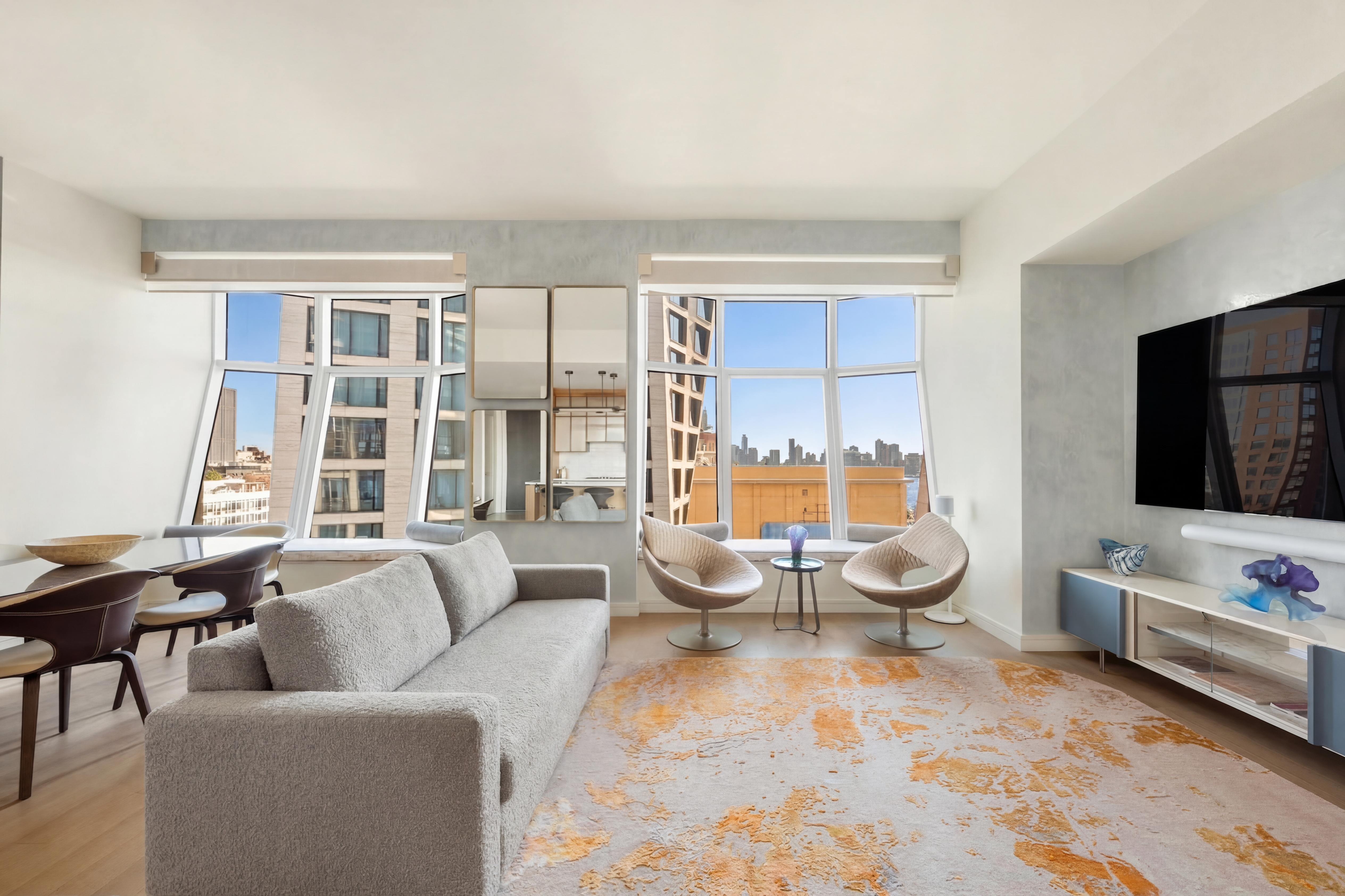 515 West 18th Street, Unit 1403 Manhattan, NY 10011 - Photo 2 of 21 a living room with furniture and a flat screen tv