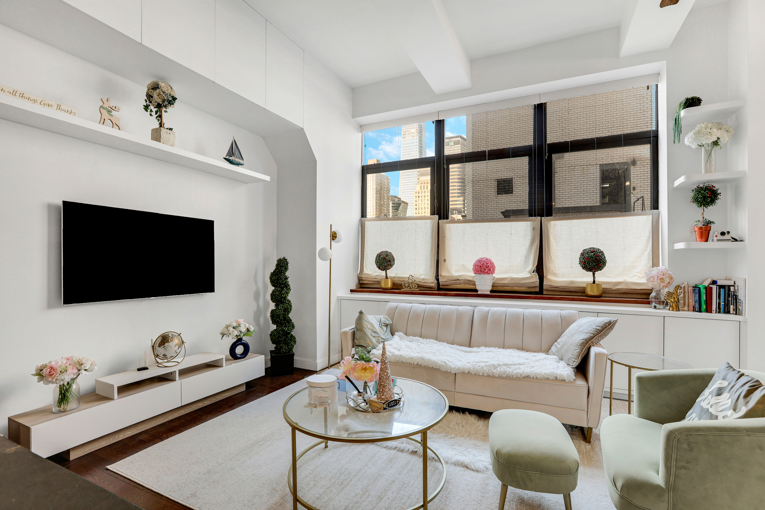 310 East 46th Street, Unit 16B Manhattan, NY 10017 - Photo 1 of 7 a living room with furniture and a flat screen tv