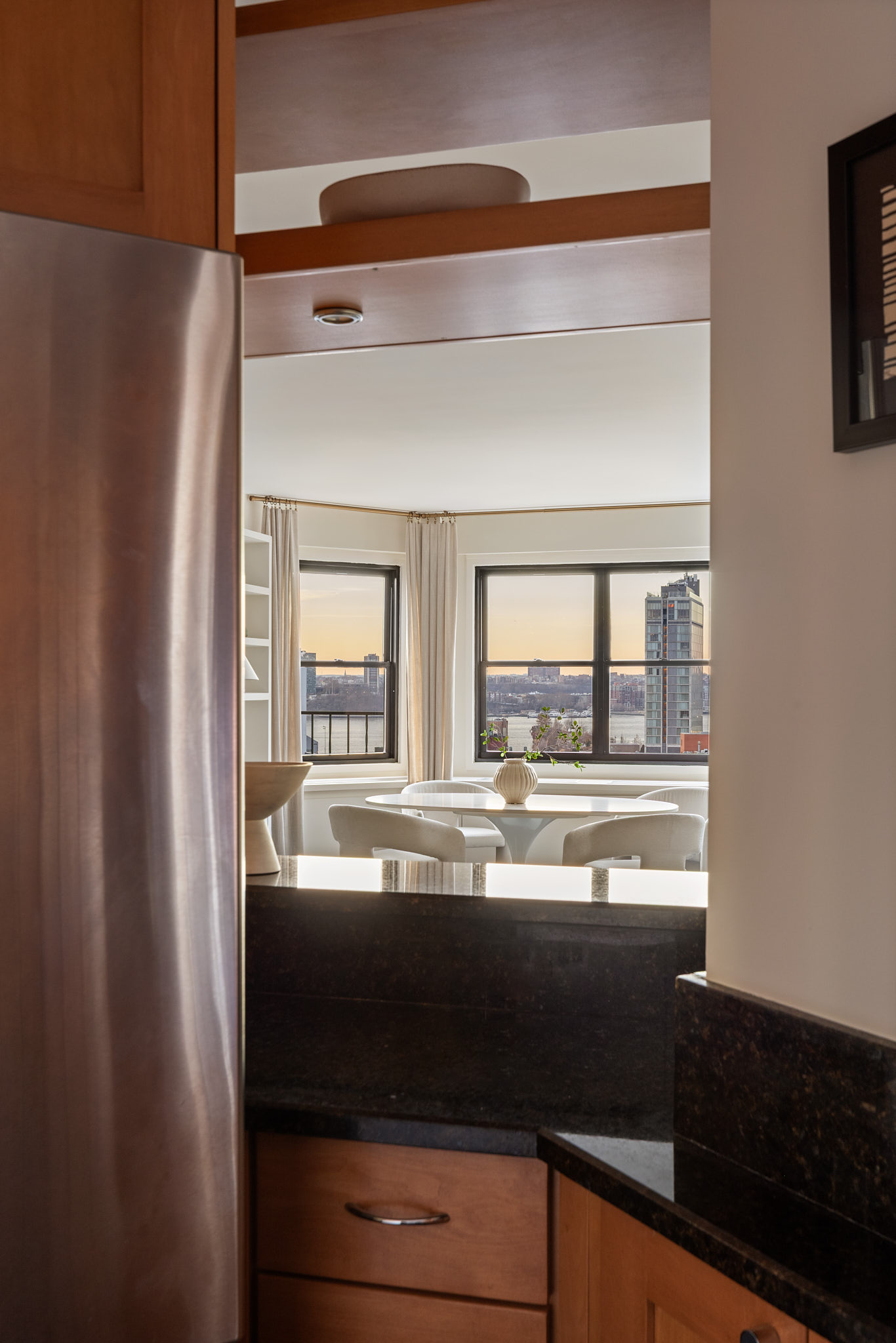 31 Jane Street, Unit 16G Manhattan, NY 10014 - Photo 9 of 20 a kitchen with a sink and large mirror