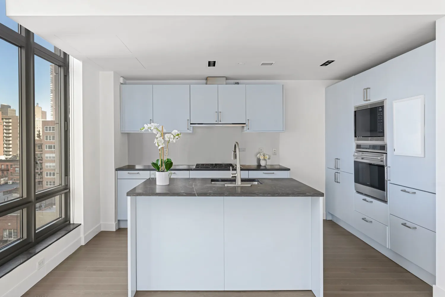 a kitchen with kitchen island granite countertop a sink and refrigerator