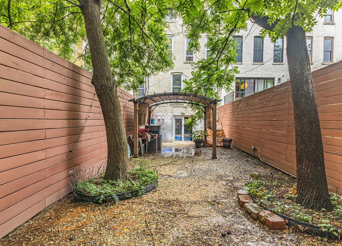 a front view of a house with garden and seating area