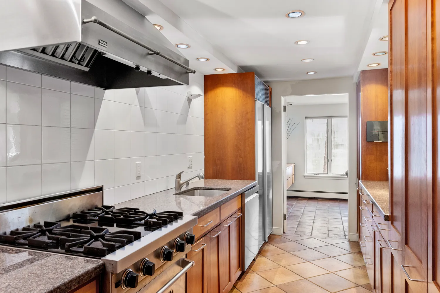 a kitchen with a stove and a refrigerator