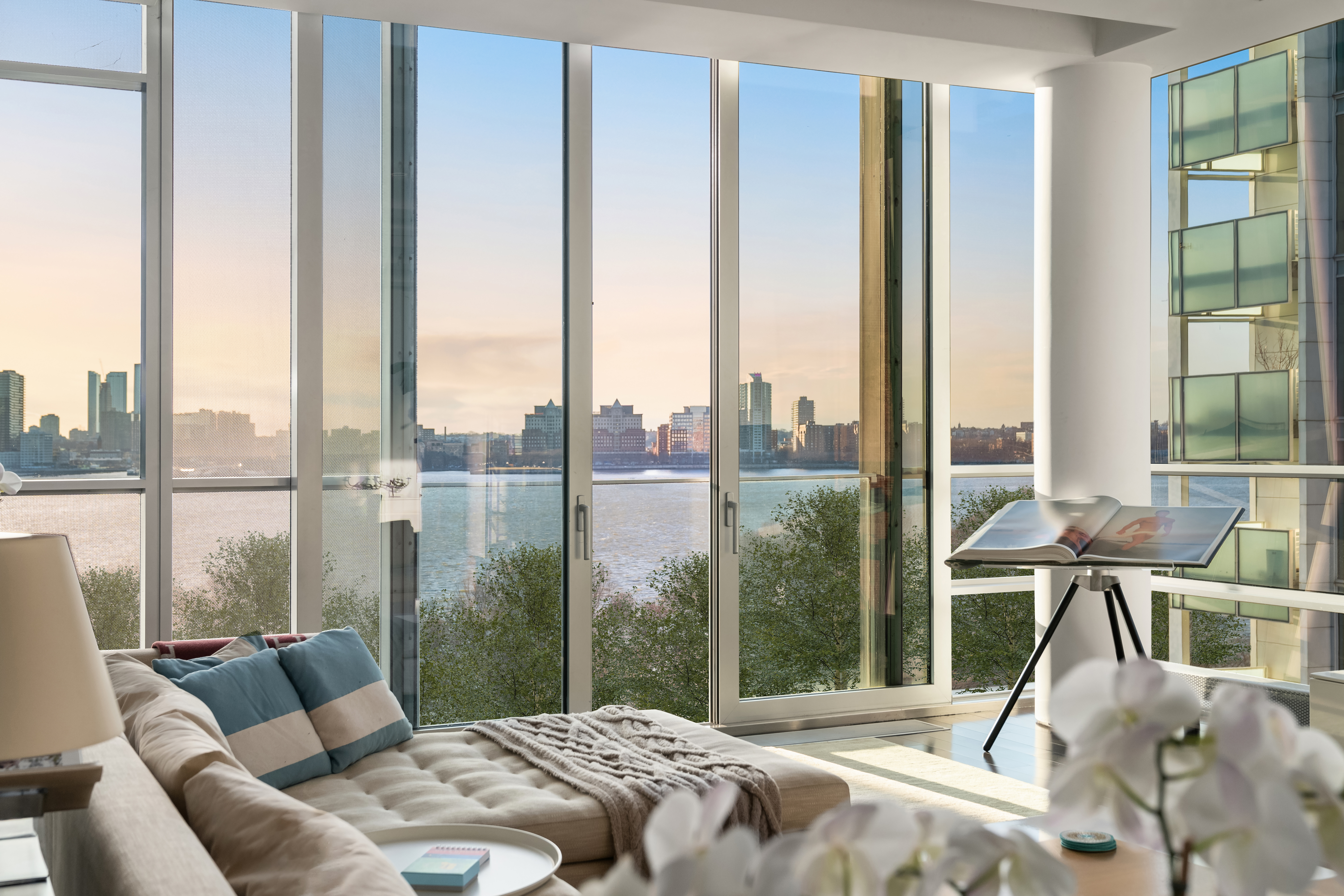 166 Perry Street, Unit 6A Manhattan, NY 10014 - Photo 2 of 20 a living room with furniture and large windows