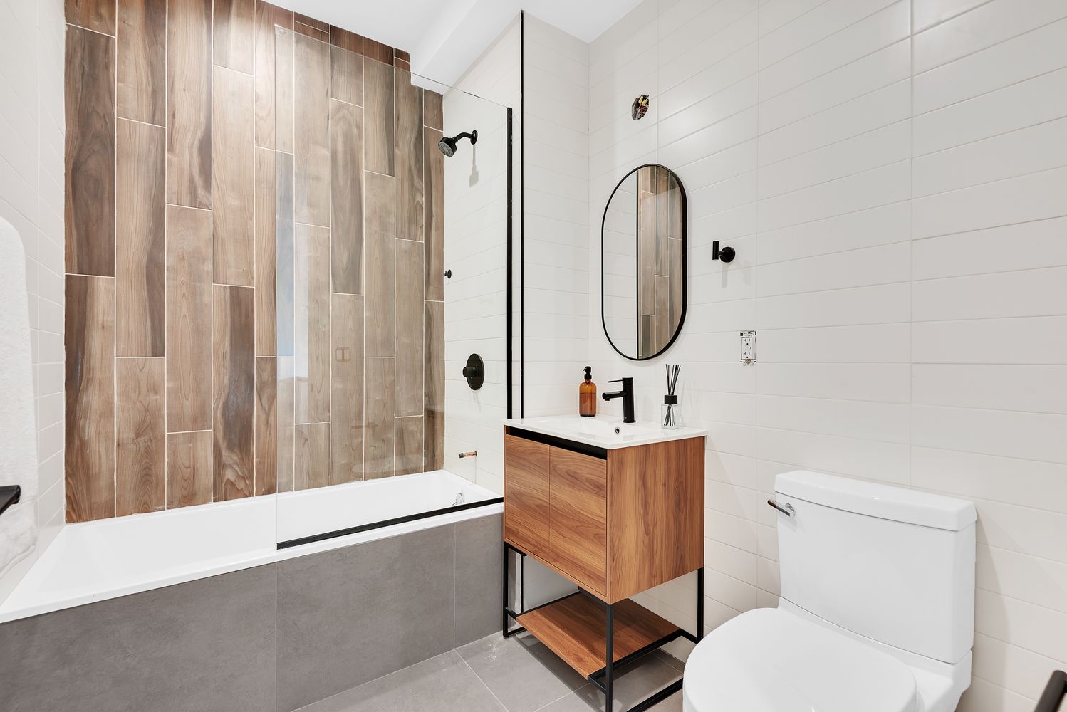 156 Somers Street, Unit 3B Brooklyn, NY 11233 - Photo 7 of 8 a bathroom with a toilet a sink and mirror
