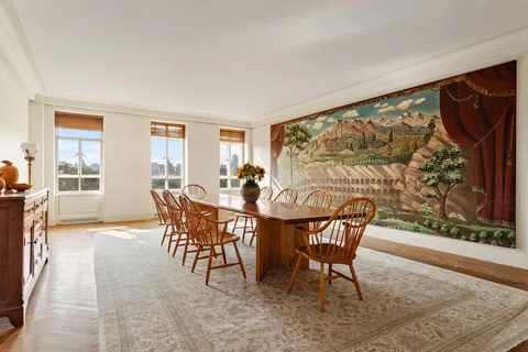 a dining room with furniture and wooden floor