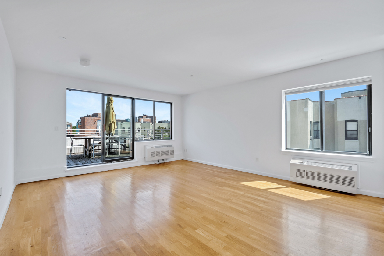 416 East 117th Street, Unit PH6 Manhattan, NY 10035 - Photo 3 of 20 a view of an empty room with a window