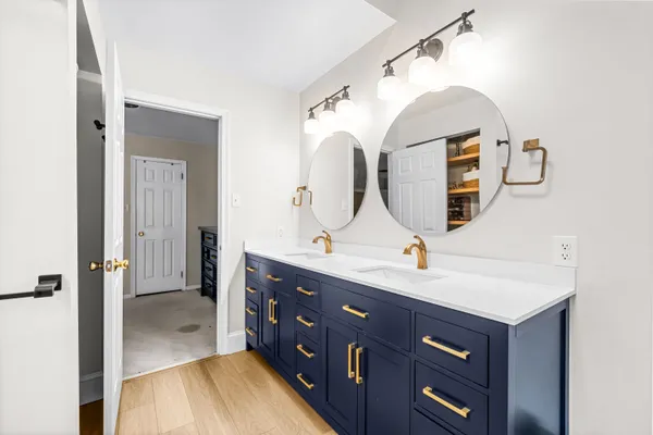 a bathroom with a double vanity sink and a mirror