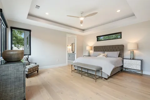 a spacious bedroom with a bed and large window
