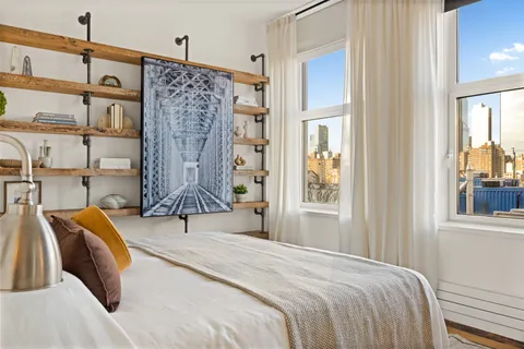 a bedroom with a bed and a window