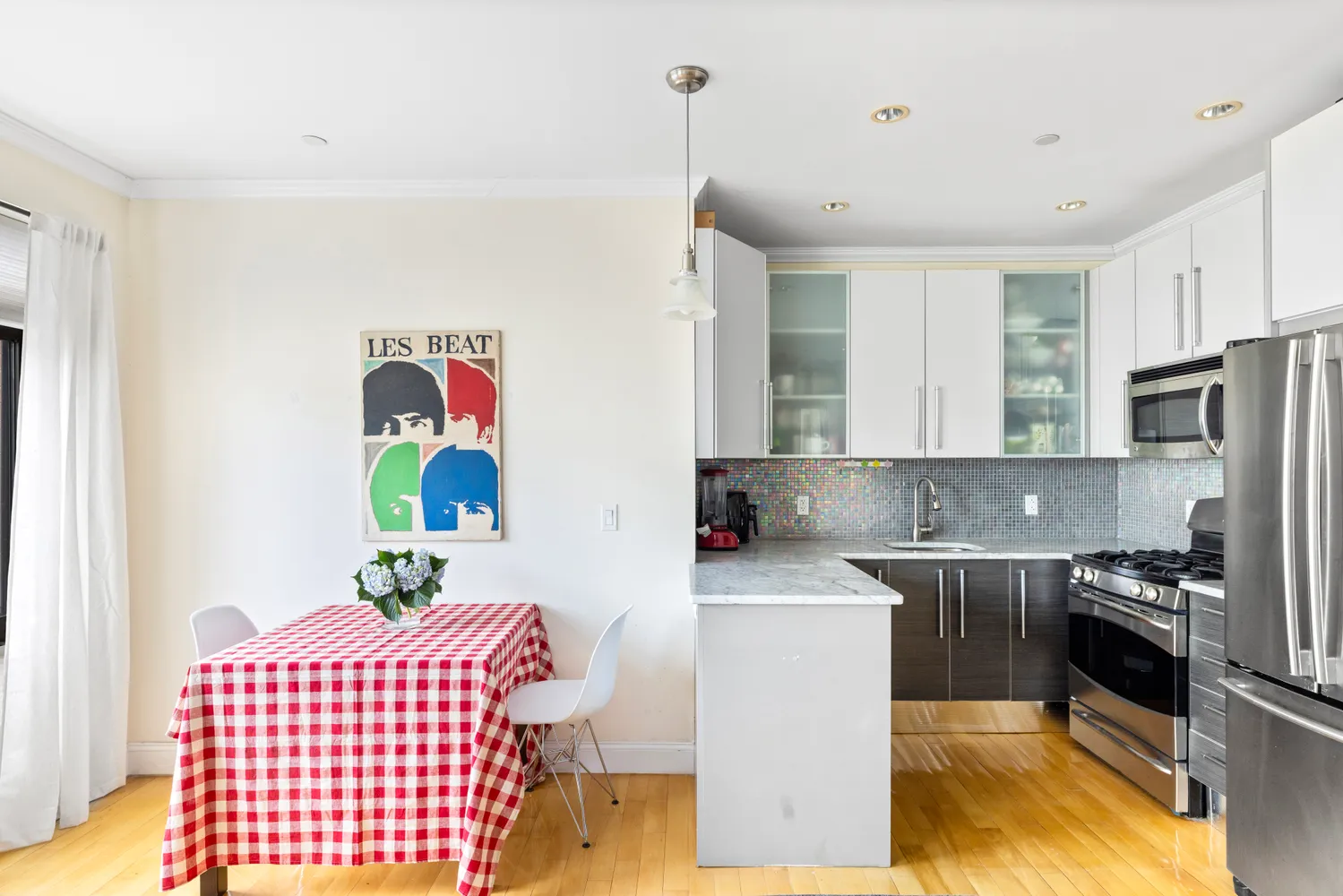 a kitchen with a sink stainless steel appliances and white cabinets