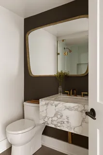 a bathroom with a sink toilet and mirror