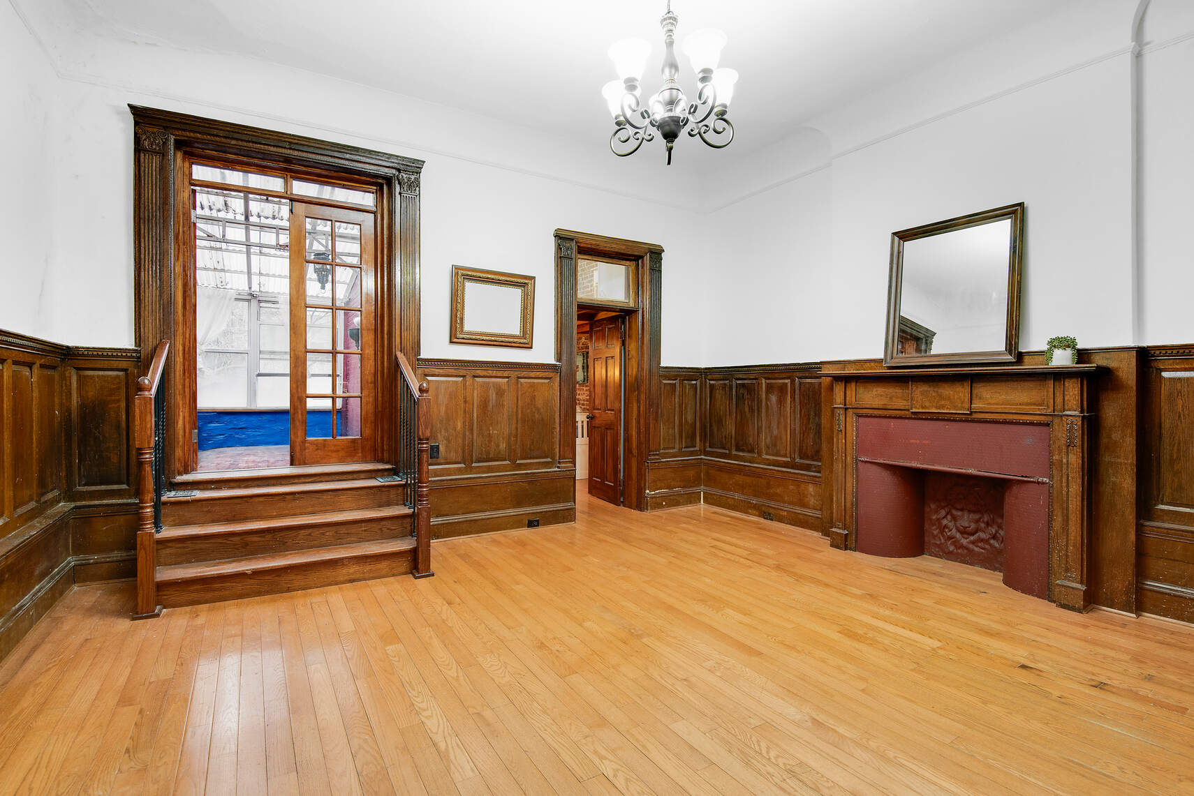 a view of livingroom with fireplace chandelier and wooden floor