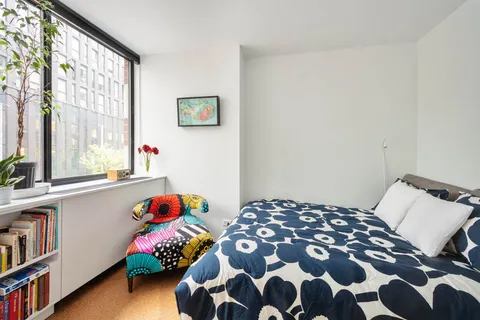 a bedroom with furniture and a flat screen tv