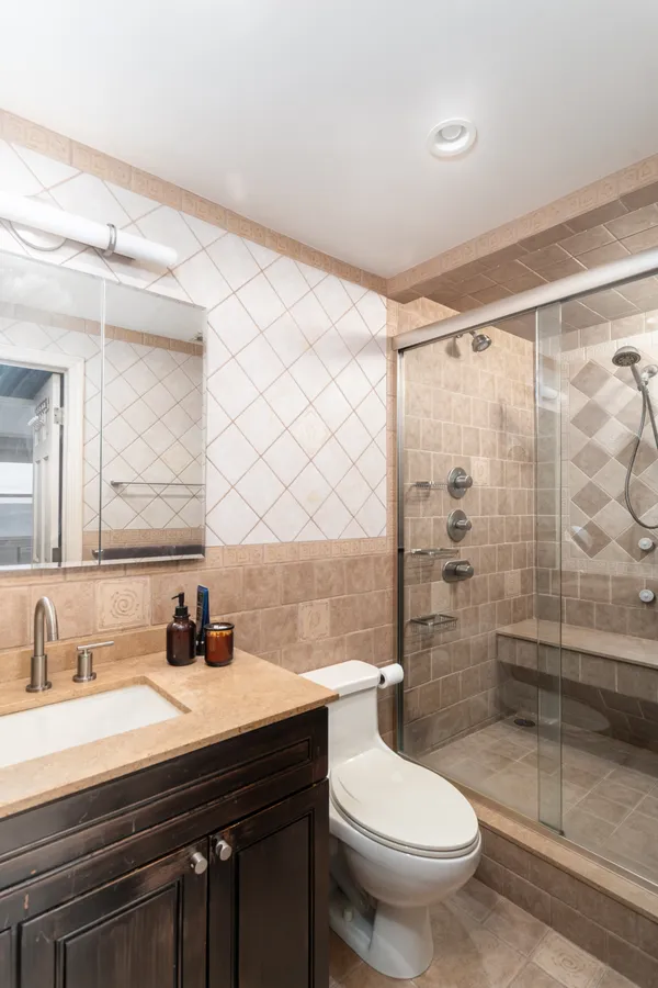 a bathroom with a sink toilet and shower