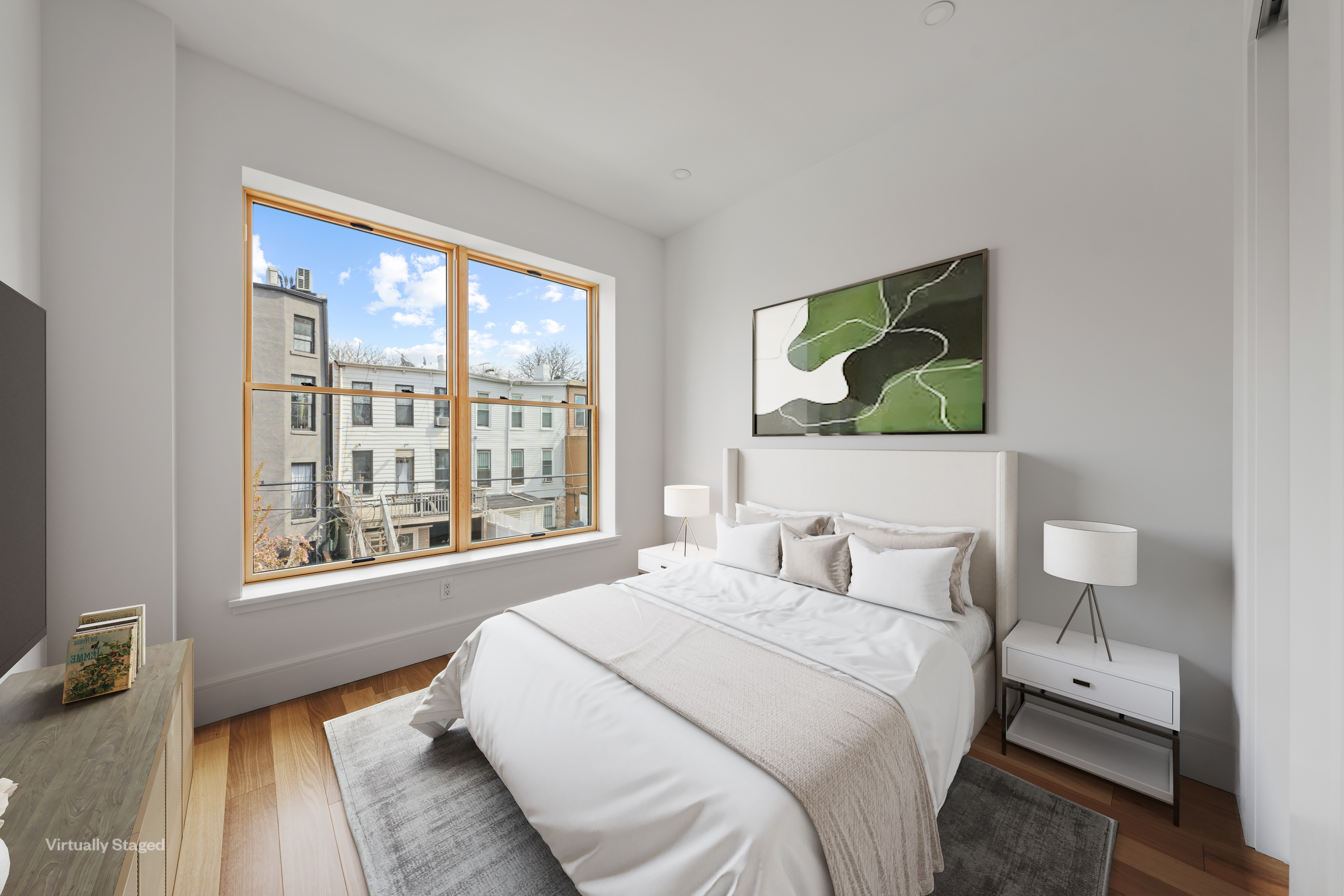 82 Cooper Street, Unit 2B Brooklyn, NY 11207 - Photo 3 of 17 a bedroom with a bed and a large window