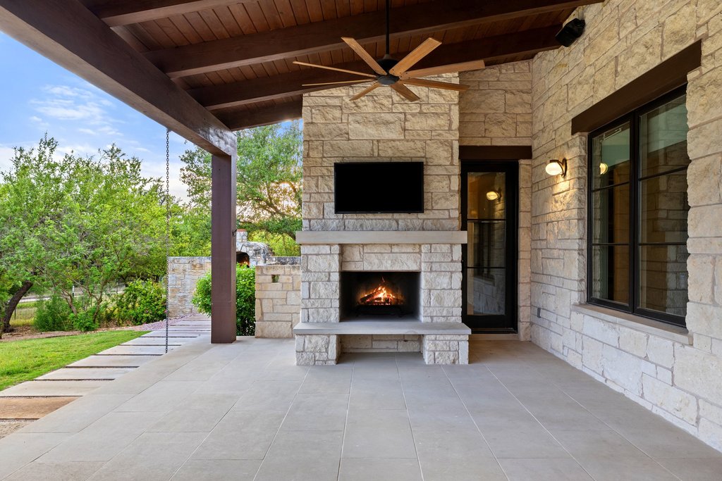 2560 Bell Springs Road Dripping Springs, TX 78620 - Photo 19 of 42 a view of a fireplace and an outdoor space