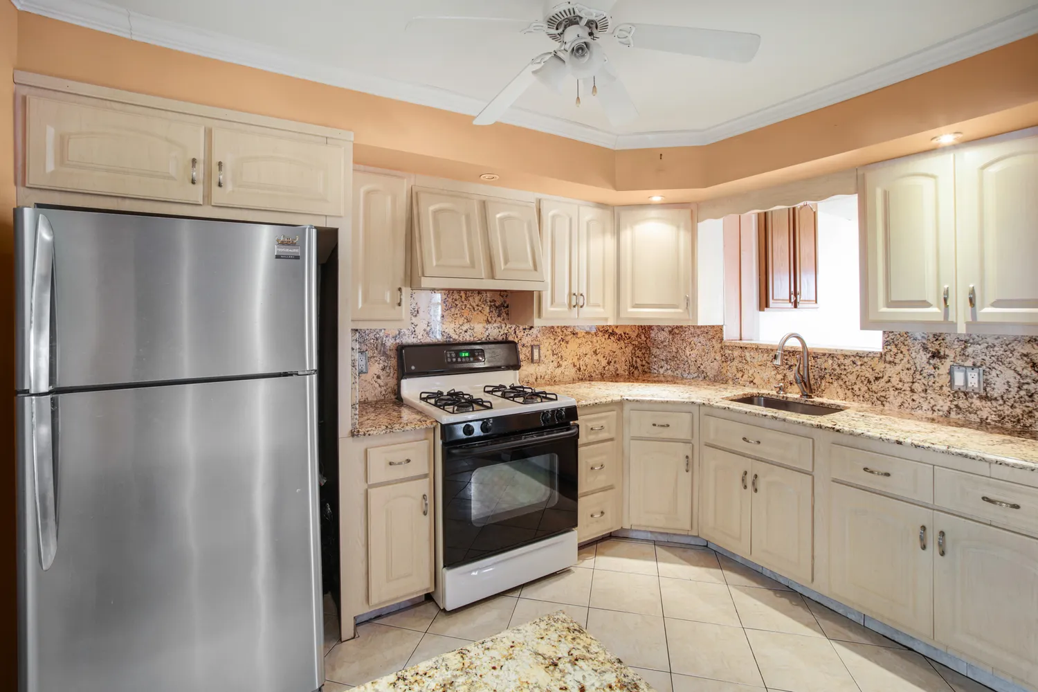 a kitchen with stainless steel appliances granite countertop a refrigerator sink and cabinets