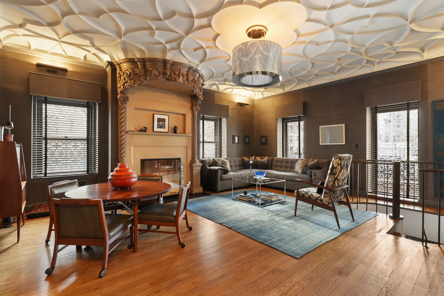 a living room with furniture a fireplace and a chandelier