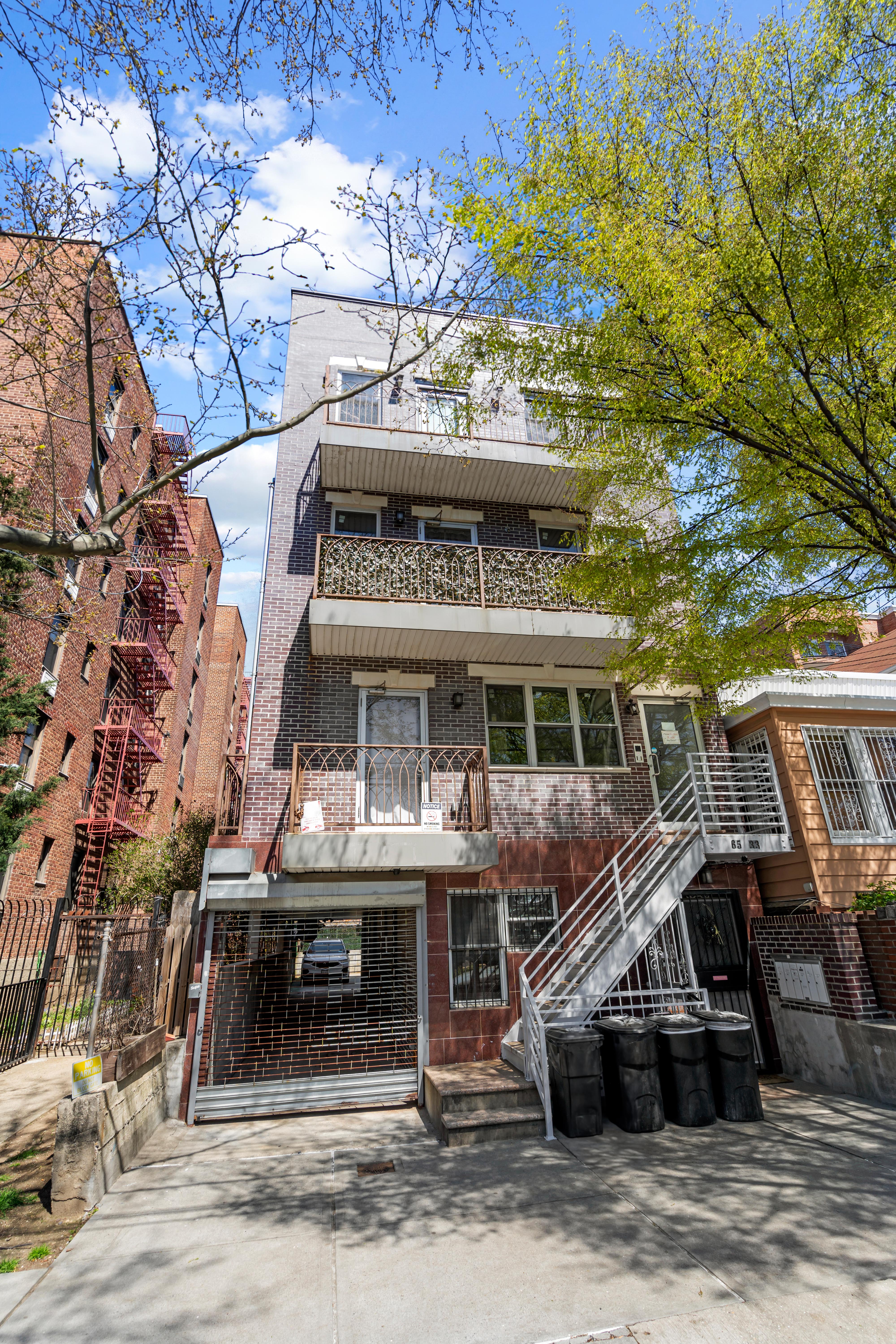 65-33 38th Avenue, Unit 5 Queens, NY 11377 - Photo 20 of 23 a front view of a house with parking space