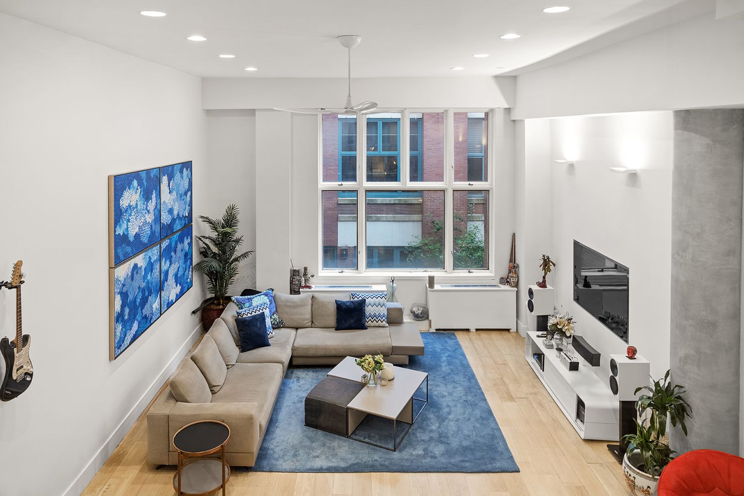 125 East 12th Street, Unit 1E Manhattan, NY 10003 - Photo 3 of 16 a living room with furniture and a flat screen tv