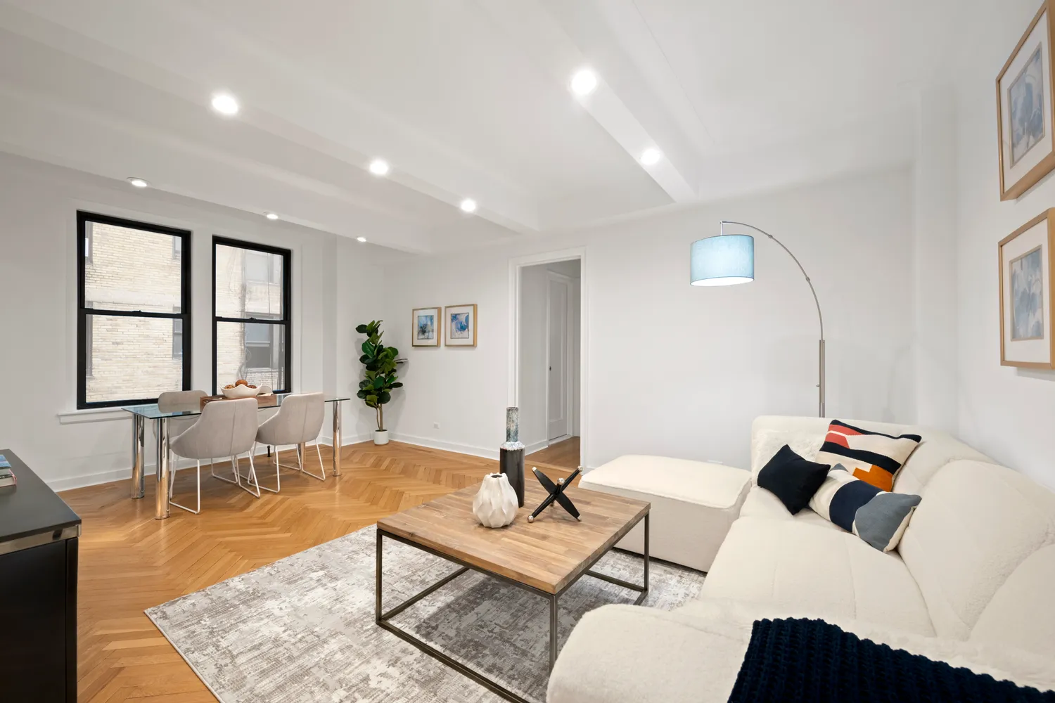 a living room with furniture a window and a table